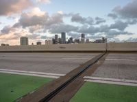 the view is from an over pass on a freeway over the city, with green markings painted on it