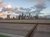 the view is from an over pass on a freeway over the city, with green markings painted on it