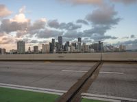 the view is from an over pass on a freeway over the city, with green markings painted on it