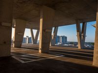 this picture is taken from underneath an overpass bridge at sunset on a clear day