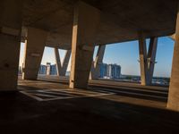 this picture is taken from underneath an overpass bridge at sunset on a clear day