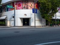 the building is painted in bright blue and white designs for cars and motorcycles with signs for street names