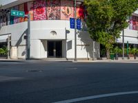 the building is painted in bright blue and white designs for cars and motorcycles with signs for street names