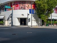 the building is painted in bright blue and white designs for cars and motorcycles with signs for street names