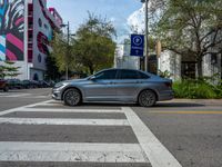 the car is waiting at the curb in the city, waiting for an urban pedestrian