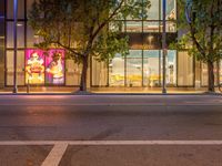 a night shot of a street scene in downtown vancouver city vancouver has many different stores