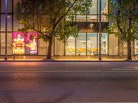 a night shot of a street scene in downtown vancouver city vancouver has many different stores