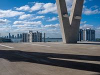 a view of the sky from a building's roof in front of a large bridge