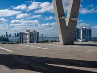 a view of the sky from a building's roof in front of a large bridge