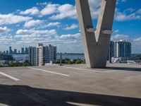 a view of the sky from a building's roof in front of a large bridge