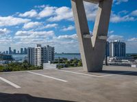 a view of the sky from a building's roof in front of a large bridge