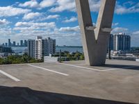 a view of the sky from a building's roof in front of a large bridge