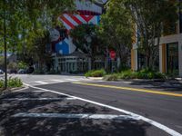 a street corner with the lines painted all over it's side and buildings and trees