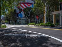 a street corner with the lines painted all over it's side and buildings and trees