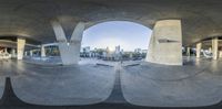 a view of the city in an angle of fisheye lens at the bottom of an arched platform