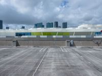 a parking lot and a building that has a sky scrape on the roof area of it