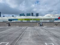 a parking lot and a building that has a sky scrape on the roof area of it