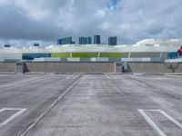 a parking lot and a building that has a sky scrape on the roof area of it