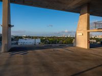 a concrete building that has some stairs by it and a city skyline on the other side