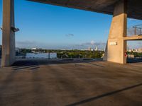 a concrete building that has some stairs by it and a city skyline on the other side