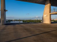 a concrete building that has some stairs by it and a city skyline on the other side