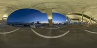 this is a fish eye lens view from an overpass in a city at dusk