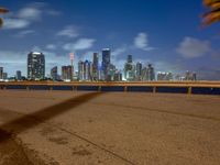 a view of the miami skyline from the beach area at night on the west side of the bay