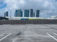 a empty parking lot in front of a bunch of tall buildings and other office buildings