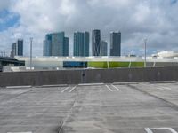 a empty parking lot in front of a bunch of tall buildings and other office buildings