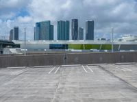 a empty parking lot in front of a bunch of tall buildings and other office buildings