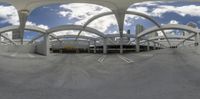 this is an image of a fish - eye lens looking down onto the street with a sky background