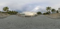 a panoramic view of a city square with lots of benches and steps and water