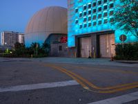 there is a blue light on the building that houses a space station and two large domes