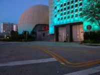 there is a blue light on the building that houses a space station and two large domes