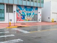 a colorful art mural on a building near the street corner in downtown honolulu, hawaii