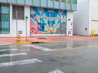 a colorful art mural on a building near the street corner in downtown honolulu, hawaii