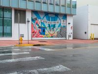 a colorful art mural on a building near the street corner in downtown honolulu, hawaii