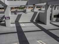 the shadows of a parking garage are cast onto the concrete in the daytime sun shines through the windows