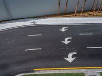 an overhead view of two roads in the same direction and arrows drawn on the road