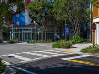 a traffic light is displayed on the side of the road, near an office building and trees