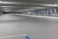 an empty parking garage with the blue and white color markings painted on the floor and no people standing