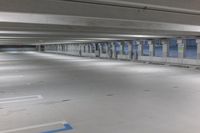 an empty parking garage with the blue and white color markings painted on the floor and no people standing