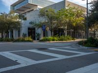 a street corner that looks very neat and empty in the daytime light at an office building