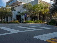 a street corner that looks very neat and empty in the daytime light at an office building