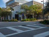 a street corner that looks very neat and empty in the daytime light at an office building