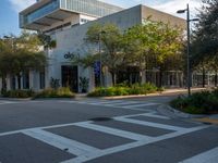 a street corner that looks very neat and empty in the daytime light at an office building