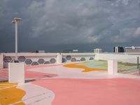 a skateboard sits atop the surface of a city building with a painted sidewalk and walkway