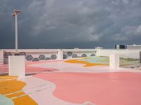 a skateboard sits atop the surface of a city building with a painted sidewalk and walkway