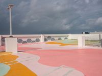 a skateboard sits atop the surface of a city building with a painted sidewalk and walkway