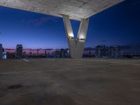 the rooftop parking deck has great view of a city below it and blue sky above